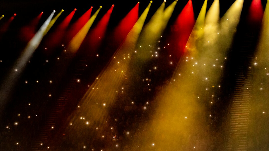 Colourful stage lights shining through haze
